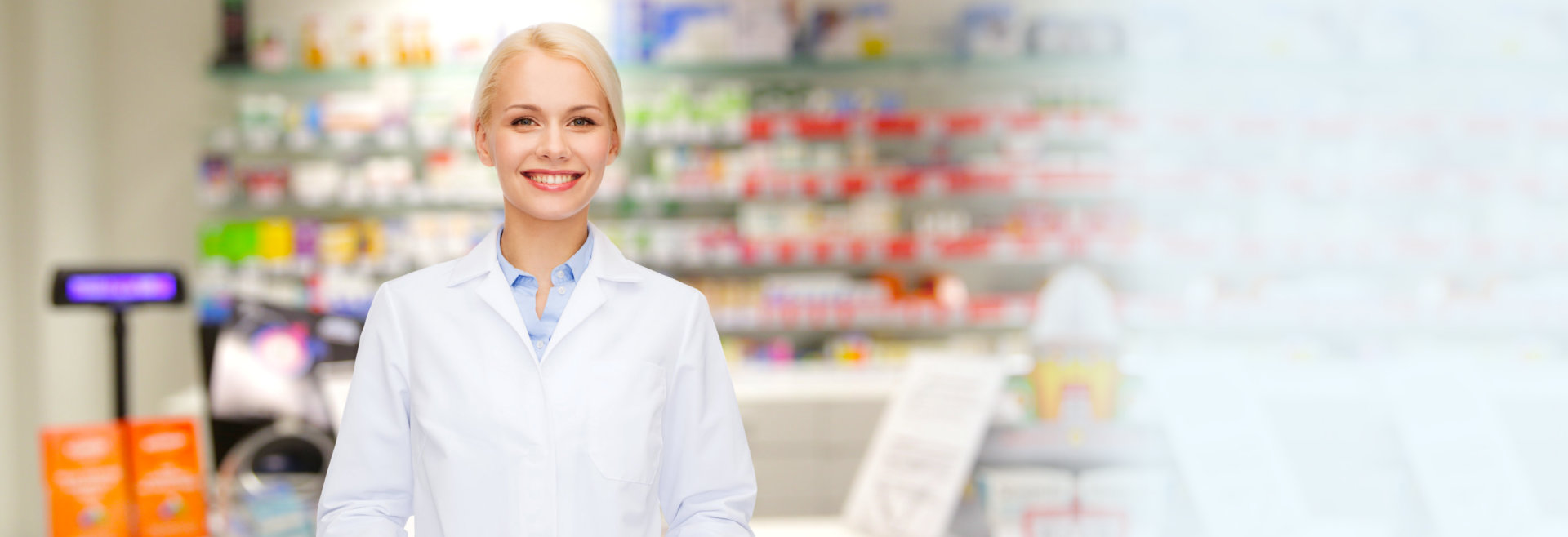 happy young woman pharmacist over drugstore background